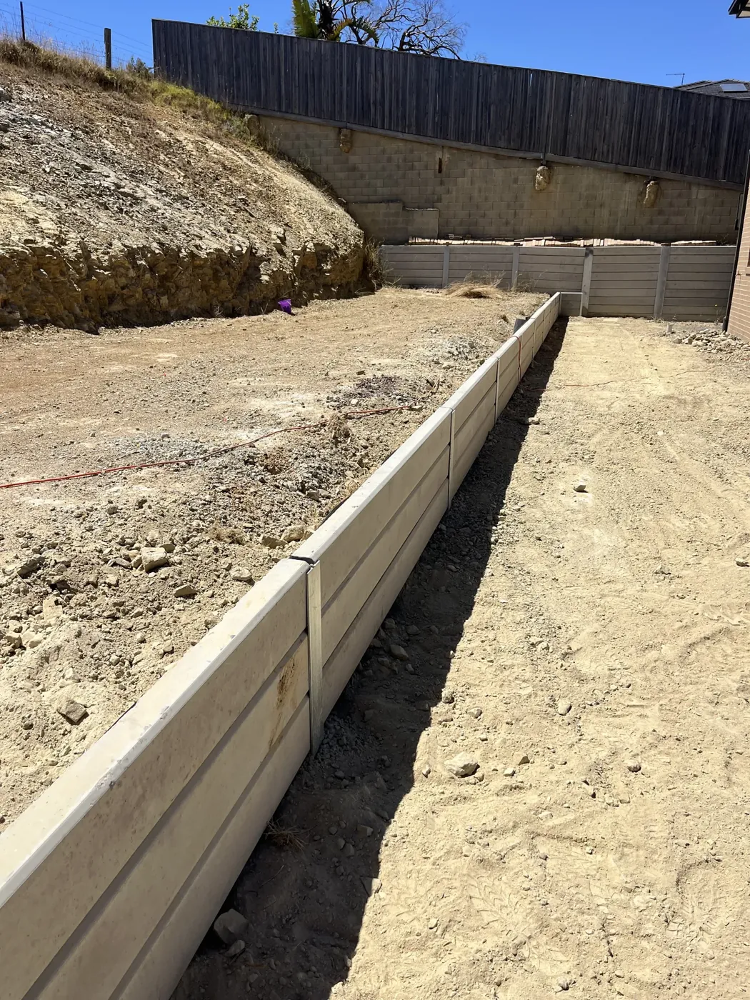 Concrete sleeper being craned into position