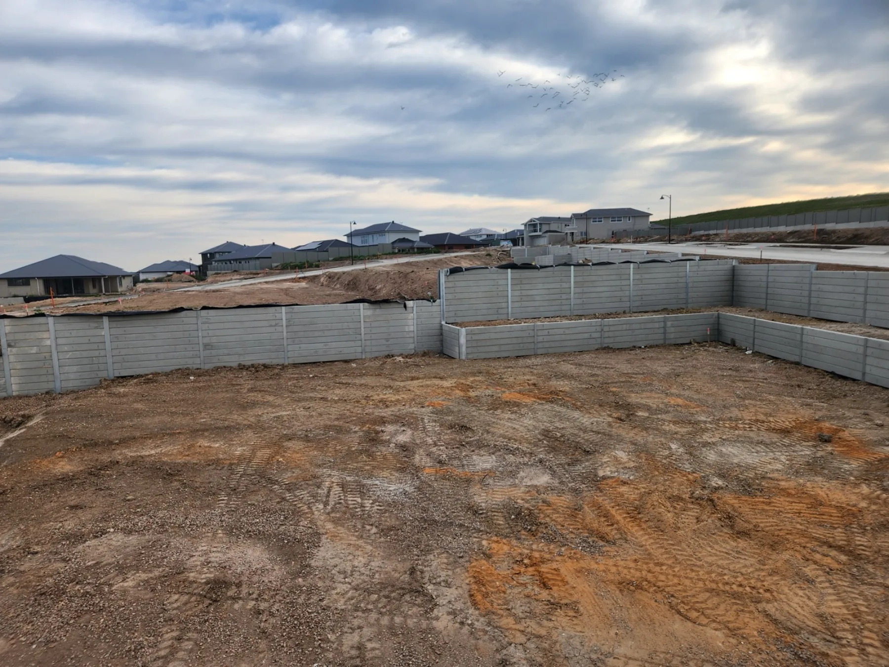 Completed wall with fencing above