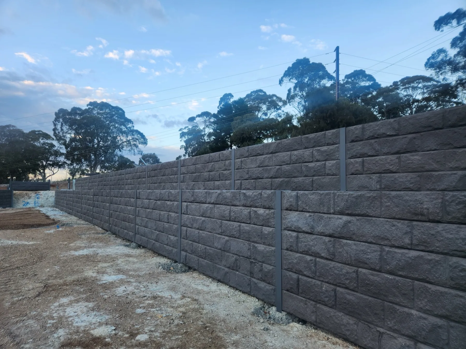 Concrete sleeper retaining wall on a sloped block
