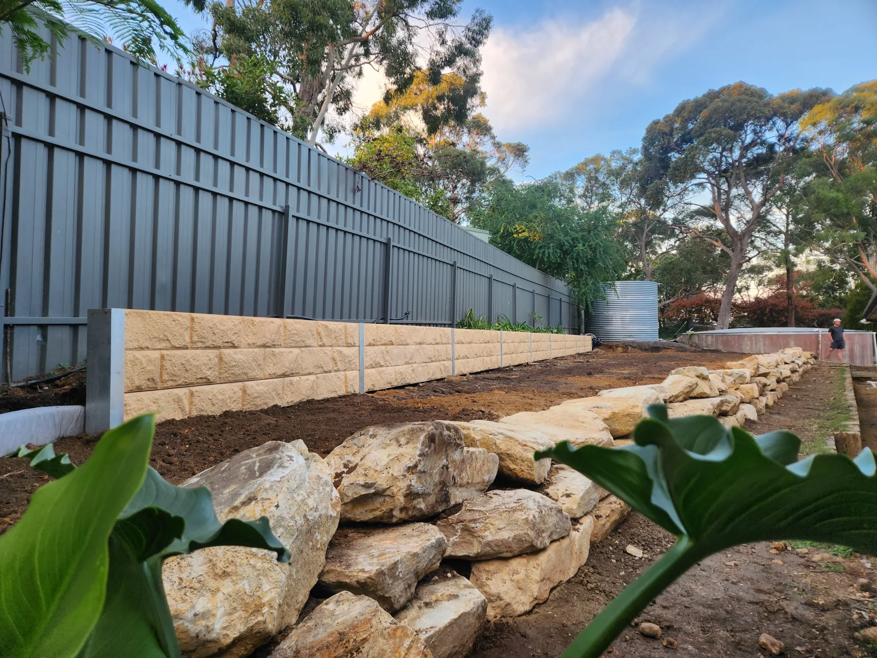 Boundary retaining wall with tight access