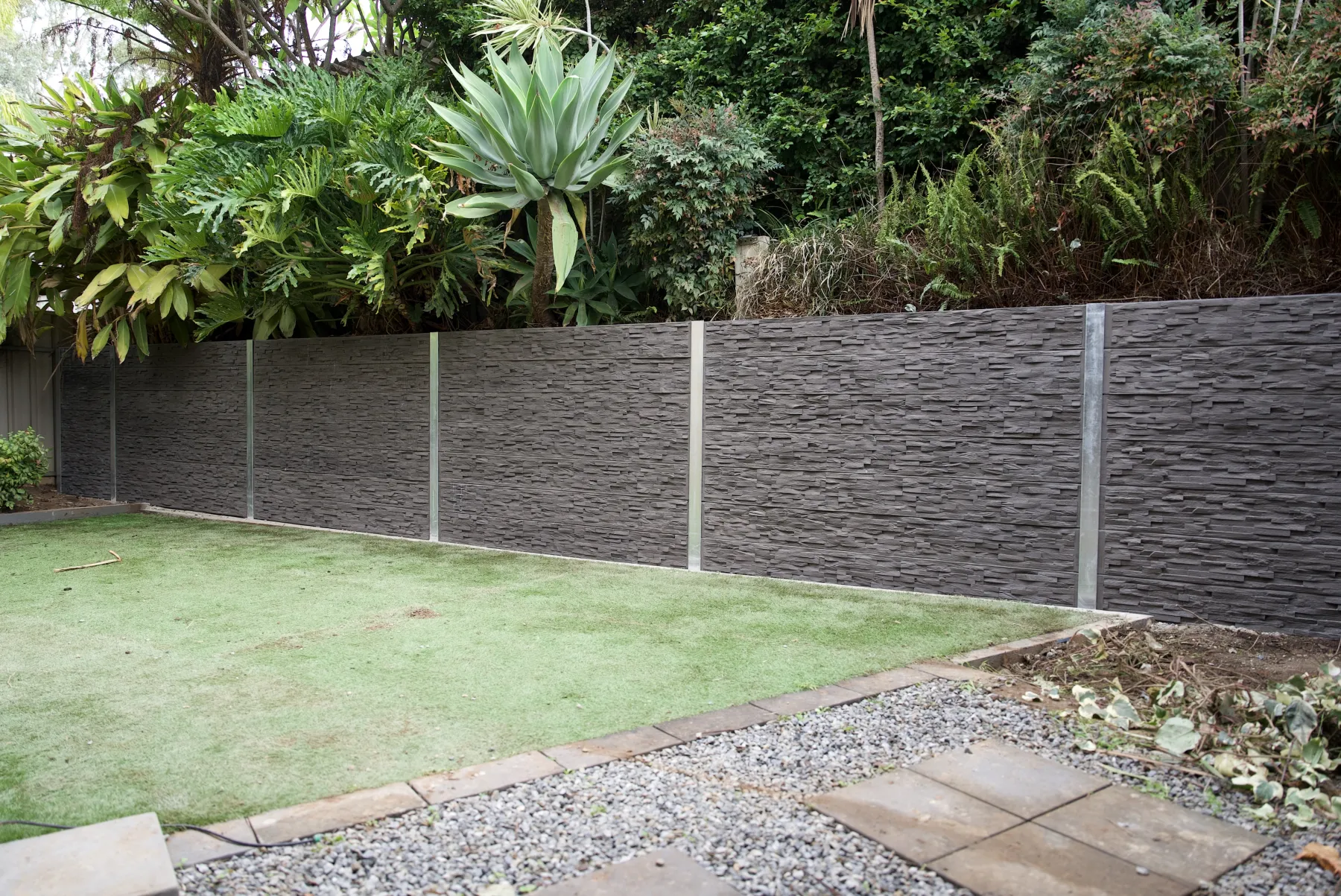 Long sleeper wall along a driveway